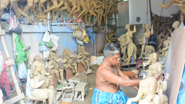 An artist works on earthen idols for worship at his workplace in Agartala Monday after easing of lockdown restrictions. Image: Indigenousherald