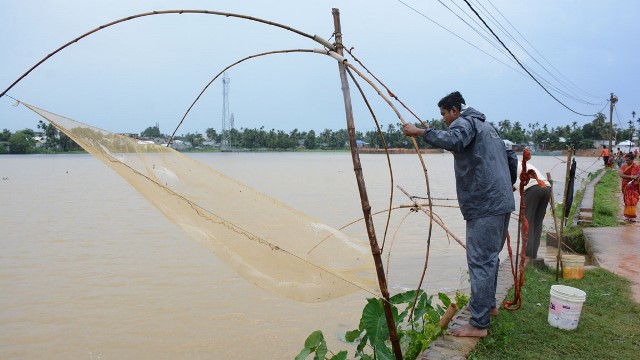 Enthusiasts catch fish with help of net as rain water inundated low lying areas of Agartala Friday. Image: Indigenousherald 