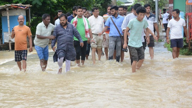 BJP aspirant from 6-Agartala constituency in the ensuing by-elections in Tripura Dr Ashok Sinha and party workers Saturday wade through a flooded street in Agartala to campaign. Image: Indigenousherald  