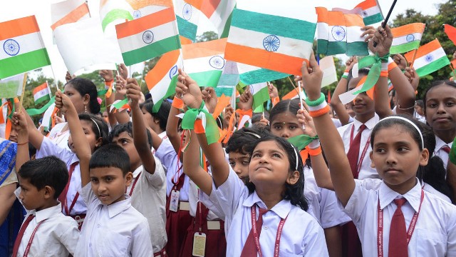 School Children wave national flag during a programme to mark 75th year of India’s independence in Agartala Sunday. Image: Indigenousherald 