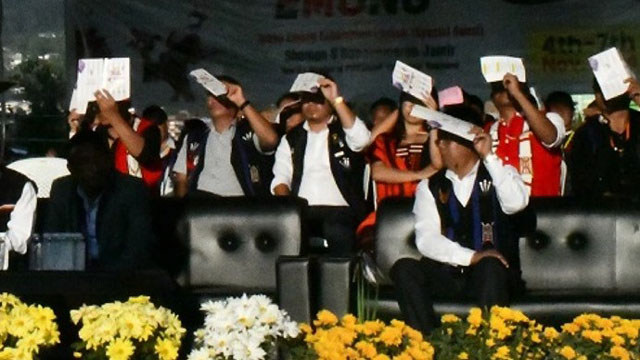 Officials and guests try to protect their face from sun ray at a programme in Wokha, Nagaland Tuesday. Image: Indigenousherald